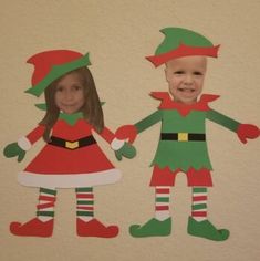 paper cut out of two children dressed as elves