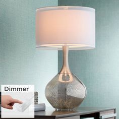 a table lamp with a white shade on it