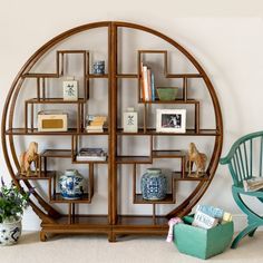 a circular shelf with books and vases on it