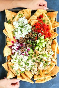 a tray filled with nachos and toppings