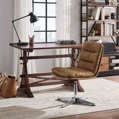 a brown chair sitting in front of a wooden desk