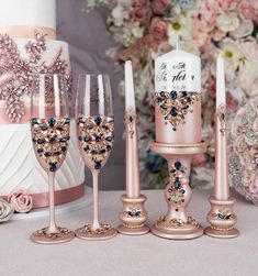 a table topped with pink and gold wedding decorations