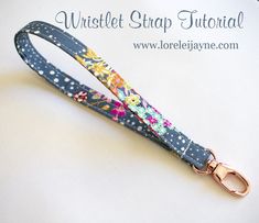 a dog leash with flowers on it sitting on top of a white table next to the words, wristlet strap tutorial