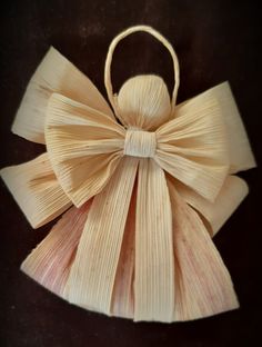 an ornament made out of paper with a bow