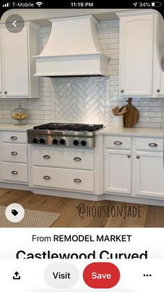 a kitchen with white cabinets and an appliance on the phone showing it's price