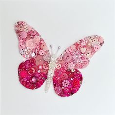 a pink butterfly made out of buttons and sequins on a white background,