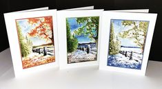 three greeting cards with trees and water on them