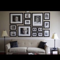 a living room filled with furniture and framed pictures on the wall above it's couch