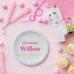 a pink table topped with cupcakes and a plate that says happy birthday willow