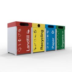 four different colored recycling bins with labels on them