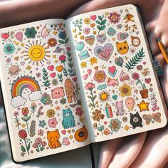 an open notebook with colorful stickers on it and a pen laying next to it