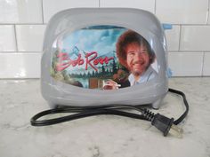 an electric toaster with the image of bob ross on it