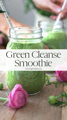 green cleanse smoothie in a mason jar on a wooden table with pink roses