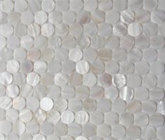 an image of white shells on the wall in this bathroom design idea, which is part of a mosaic tile pattern