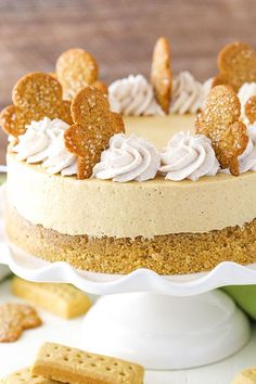 a close up of a cake on a plate with crackers around it and some cookies