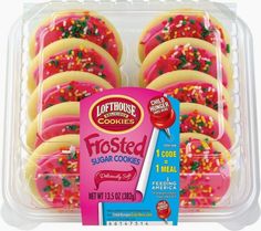 frosted sugar cookies with sprinkles are in a plastic container on a white background