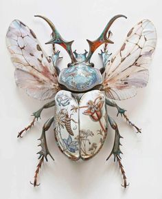 a bug made out of metal and painted with different designs on it's wings