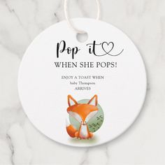 a white round ornament with an image of a fox on it and the words pop to when she pops