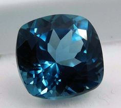 a blue diamond sitting on top of a white surface