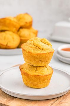 three muffins stacked on top of each other on a plate next to some dipping sauce