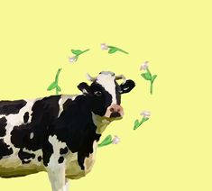 a black and white cow standing in front of a yellow wall with green leaves on it