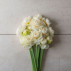 a bouquet of white flowers sitting on top of a table