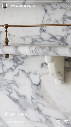 a marble counter top with brass handles and knobs