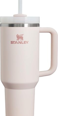 a white travel mug with a straw in the cup and stanley logo on the side