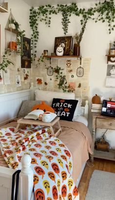 a bedroom with lots of plants on the wall and pictures above the bed in it