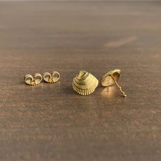 These charming golden shell studs are the perfect mix of organic and elegant. 18k yellow gold Shells 10mm x 9mm (3/8" x 3/8") Each earrings weighs 0.8g Yellow Gold Shell-shaped Earrings For Pierced Ears, Yellow Gold Shell-shaped Earrings, Shell-shaped Yellow Gold Earrings Gift, Shell-shaped Yellow Gold Earrings For Gifts, Yellow Gold Shell-shaped Earrings Gift, Venus Shell, Cast Rings, Button Studs, Coral Beads Necklace