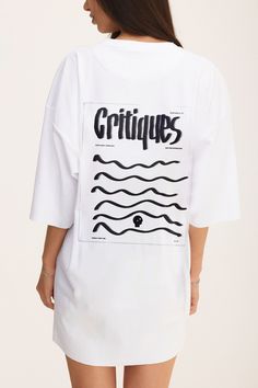 Elevate your casual style with our white cotton oversized T-shirt, featuring a bold "Critiques" print on the back. Perfect for those who embrace the power of feedback and growth, this tee offers a relaxed, oversized fit with lowered shoulders for a modern, laid-back silhouette. Made from soft, high-quality cotton, it provides all-day comfort, whether you're out exploring or simply lounging at home. The minimalist yet striking "Critiques" print adds a thoughtful edge to your wardrobe, making it a White Drop Shoulder T-shirt With Graphic Print, White Boxy Fit T-shirt With Graphic Print, White Drop Shoulder Top With Text Print, White T-shirt With Graphic Print And Drop Shoulder, Oversized White Tops With Screen Print, Oversized White Top With Screen Print, White Trendy T-shirt With Back Print, Oversized White T-shirt With Logo Print, Trendy White T-shirt With Back Print