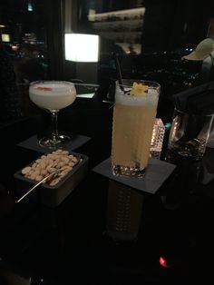 two drinks are sitting next to each other on a table