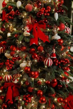 a decorated christmas tree with red and white ornaments