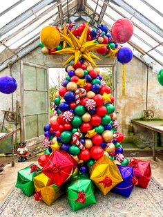 a christmas tree made out of balloons in a greenhouse