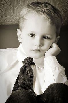 a young boy wearing a shirt and tie