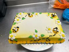 a cake with yellow frosting and white flowers on it