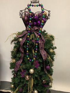 a purple and green christmas tree with ornaments