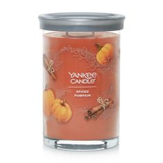 yankee candle with pumpkins and cinnamon on the inside, in a glass jar against a white background