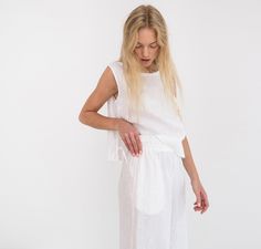 "AVERY is a linen tank top with side ties. DETAILS - Sleeveless design - Crew Neck - Side Ties - Straight cut - 100% lightweight European linen fabric - Cut and sewn to order just for you in our studio COLOR - White (slightly see through), you can also choose other colors above - Fabric samples are available here https://www.etsy.com/listing/586569696/linen-fabric-samples SIZING & FIT - Fits true to size - Length is approximately 19 inches / 48 cm - Bust is approximately 19 inches / 48 cm - Sleeveless Linen Tank Top For Daywear, Linen Sleeveless Top, Wide Leg Linen Trousers, Linen Dress Summer, Sleeveless Linen Dress, Linen Crop Top, Studio Color, Linen Tank Top, Linen Crops