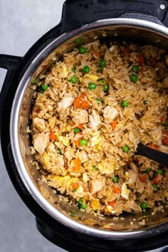 a pot filled with rice and vegetables on top of a table