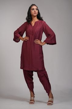 Maroon kurta with mul cotton base and front button placket. Paired with dhoti salwar.
Components: 2
Type Of Work: Plain
Neckline: Notched
Sleeve Type: Bell sleeves
Fabric: Mul Cotton
Color: Maroon
Other Details: 
Approx weight: 5-7 kgs
Model height: 5ft 9inches, wearing size M
Closure: Kurta: Front buttons
Occasion: Puja - Aza Fashions Handloom Unstitched Suit With Straight Kurta, Designer Handloom Kurta, Handloom Churidar For Diwali, Semi-stitched Salwar Kameez With Unstitched Blouse, Handloom Bollywood Style Straight Kurta Set, Bollywood Style Handloom Straight Kurta Set, Cotton Silk Unstitched Suit For Navratri, Puja Kurta With Traditional Drape, Festive Straight Kurta With Unstitched Blouse