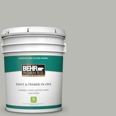 the behr paint and primer in one is shown on a gray background with white trim