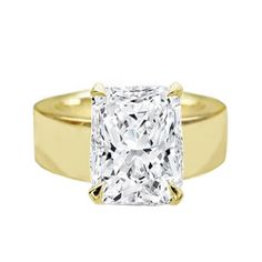 a yellow gold ring with a princess cut diamond in the center, on a white background