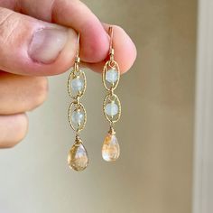 Rutilated Quartz and Aquamarine Drop Earrings, Long Aquamarine Earrings, Beaded Quartz Earrings, Dainty Minimalist Jewelry, Gift for women These dainty light earrings feature flawless rutilated quartz smooth drops suspended from three hammered oval links with aquamarine round beads wire wrapped in gold filled or sterling silver. These are light weight, dainty and extremely feminine. The color are soft and easy to match, making this pair a perfect earring for every day wear. Simple and understate Dainty Feminine Jewelry, Silver Dainty Earrings, Handmade Dainty Long Drop Earrings, Handmade Dainty Crystal Drop Earrings, Diy Wedding Jewelry, Gold Wire-wrapped Crystal Earrings, Nature-inspired Dangle Gemstone Earrings, March Stone, Handmade Aquamarine Dangle Earrings