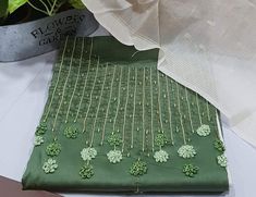 a green table cloth with shamrocks on it and a potted plant in the background