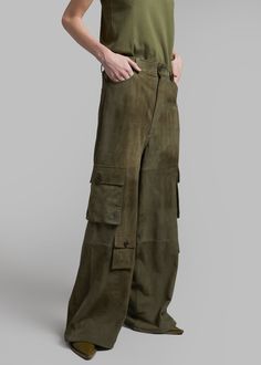 Color: Olive Midweight suede fabric Oversized cargo style Enlarged cargo pockets at each leg Slant hip pockets Back patch pockets Adjustable drawcords at hem Zip fly Front button closure Unlined 100% Goat Leather Dry Clean by Leather Specialist By The Frankie Shop. Imported Utility Wide-leg Cargo Pants With Hip Pockets, Utility Wide-leg Cargo Pants With Belt Loops, Luxury Wide-leg Utility Cargo Pants, Luxury Wide-leg Cargo Pants With Patch Pockets, Military Style Olive Parachute Pants With Pockets, Suede Fabric, Back Patch, Goat Leather, Cargo Pants