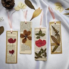 three bookmarks with flowers and leaves on them