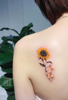 a woman with a sunflower tattoo on her back