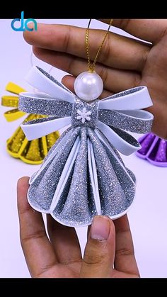 an ornament is being held up by someone's hand