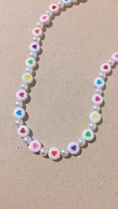 a beaded necklace with multicolored hearts on it